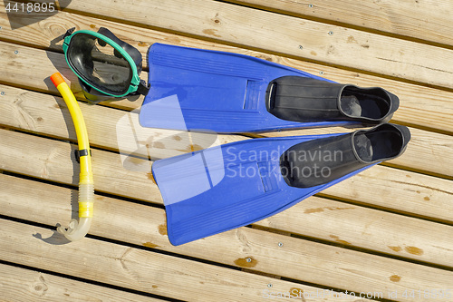 Image of Diving mask, fins, snorkel on wooden pier