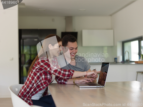 Image of happy young couple buying online