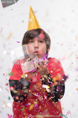 Image of kid blowing confetti