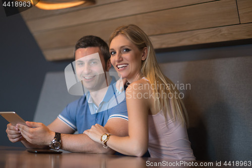 Image of couple using tablet at home