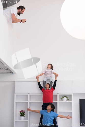 Image of young boys posing line up piggyback