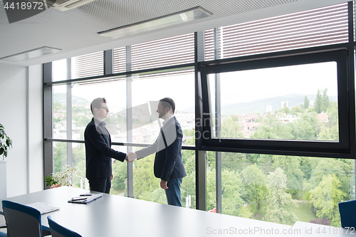 Image of cloasing the deal in modern office interior