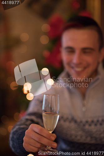 Image of Happy young man with a glass of champagne