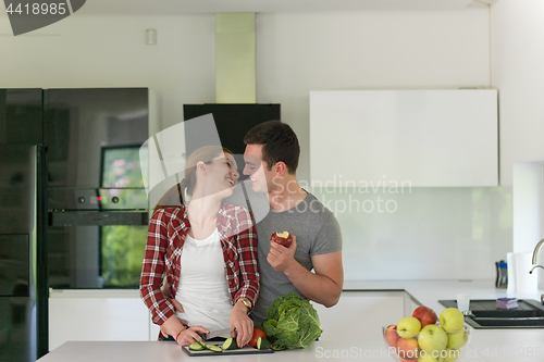 Image of Young handsome couple in the kitchen