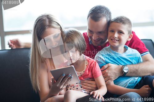 Image of happy young couple spending time with kids