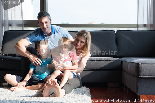 Image of happy young couple spending time with kids