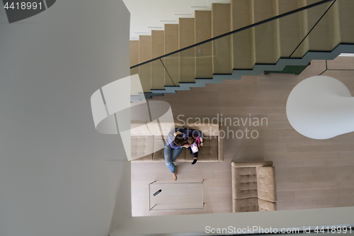 Image of mother and her cute little daughter are using a tablet top view