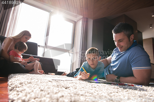 Image of young couple spending time with kids