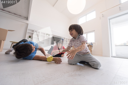 Image of boys having fun with an apple on the floor