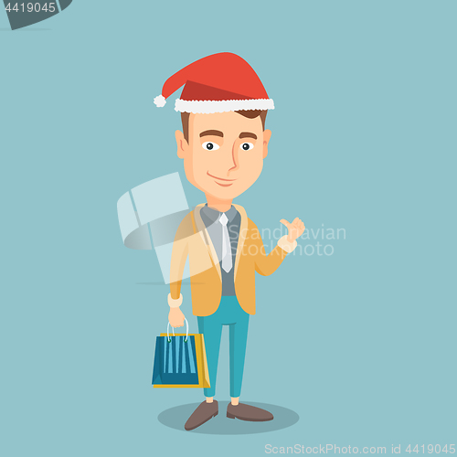 Image of Man in santa hat shopping for christmas gifts.