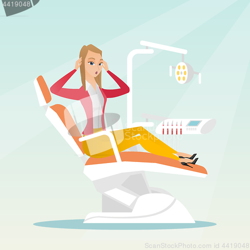 Image of Afraid woman sitting in the dental chair.