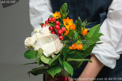 Image of Woman holding a gorgeous bouquet