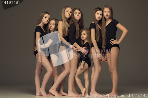 Image of The group of teen girls posing at white studio