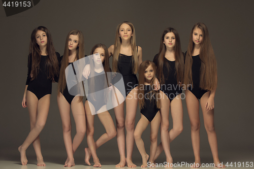Image of The group of teen girls posing at white studio