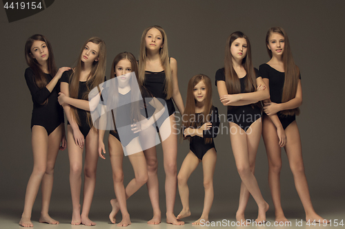 Image of The group of teen girls posing at white studio