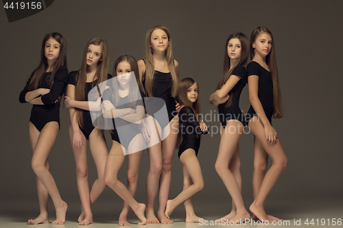 Image of The group of teen girls posing at white studio