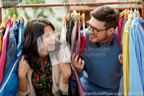 Image of happy couple having fun at vintage clothing store