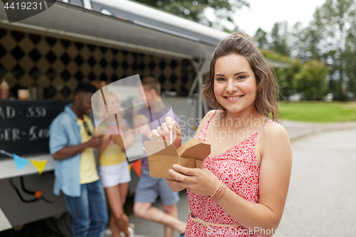 Image of happy woman with wok and friends at food truck