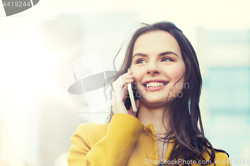 Image of smiling young woman or girl calling on smartphone