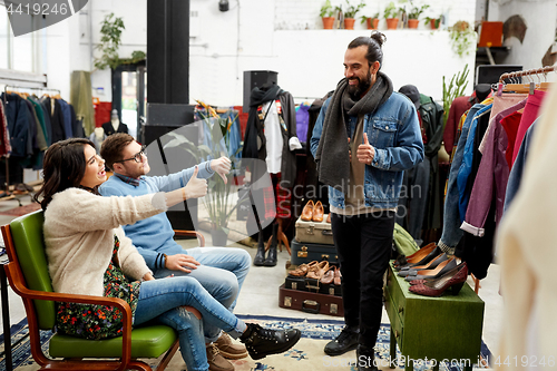 Image of friends choosing clothes at vintage clothing store