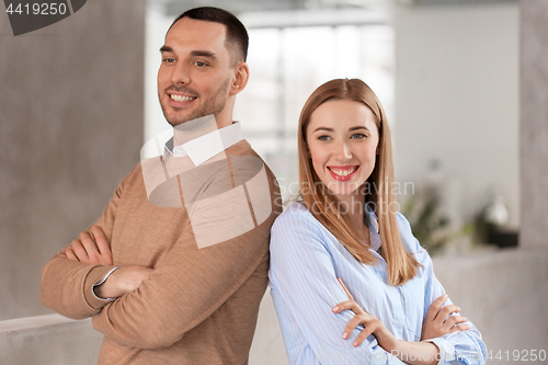 Image of smiling businesswoman and businessman at office