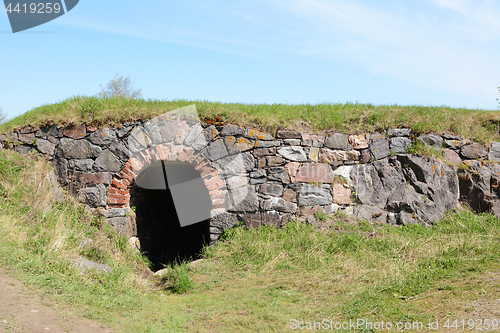 Image of Dark tunnel entrance in a stone embankment 