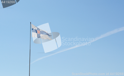 Image of State flag of Finland flies from a flagpole 