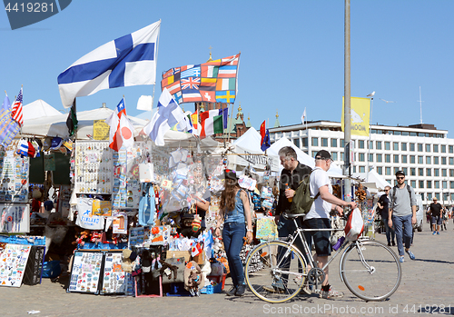 Image of Tourists peruse a souvenir stall in Helsinki