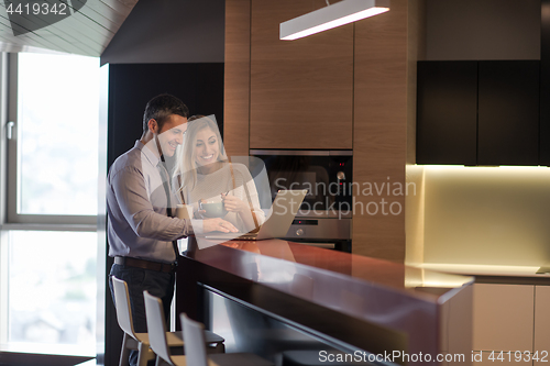 Image of A young couple is preparing for a job and using a laptop