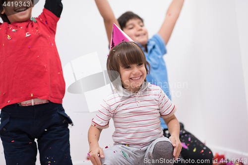 Image of kids  blowing confetti