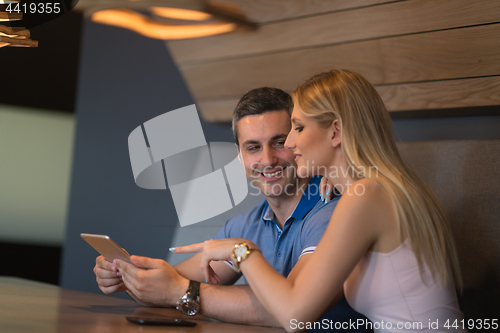 Image of couple using tablet at home