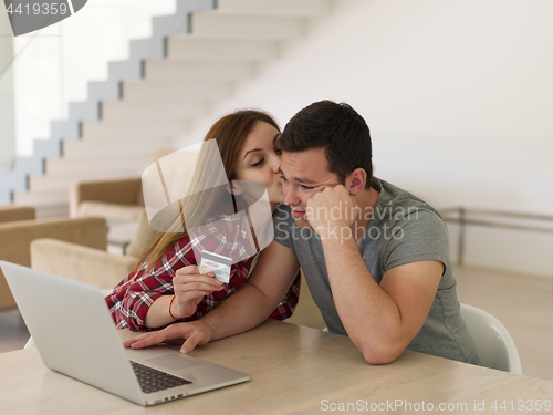 Image of happy young couple buying online