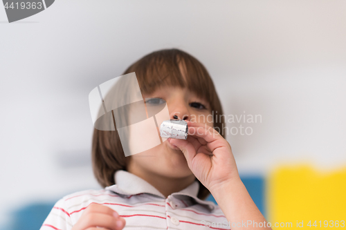Image of kid blowing a noisemaker