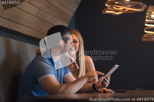 Image of couple using tablet at home