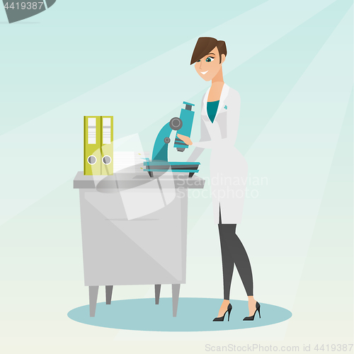 Image of Laboratory assistant with a microscope.