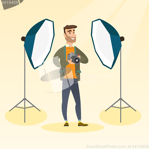 Image of Photographer with a camera in a photo studio.