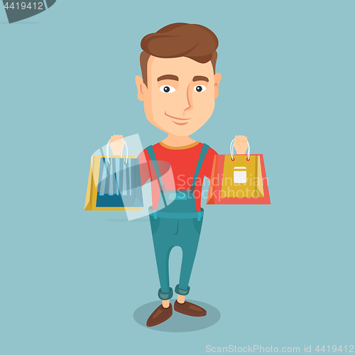 Image of Happy man holding shopping bags.