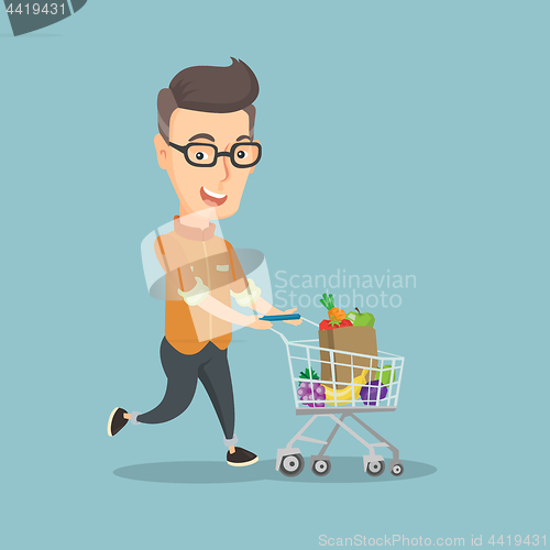 Image of Man running with a trolley full of purchases.