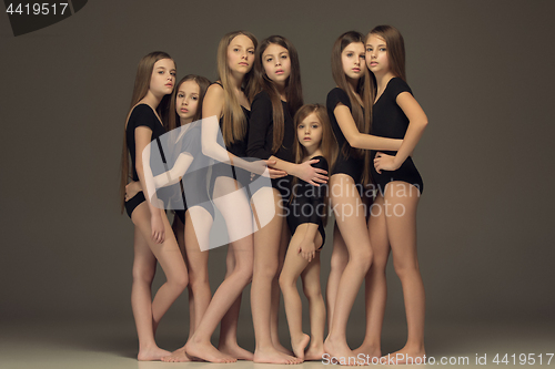 Image of The group of teen girls posing at white studio