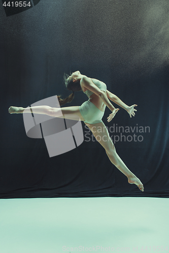 Image of Young teen dancer on white floor background.