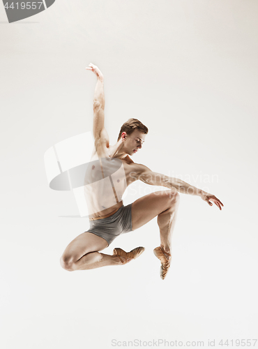 Image of The male athletic ballet dancer performing dance isolated on white background.