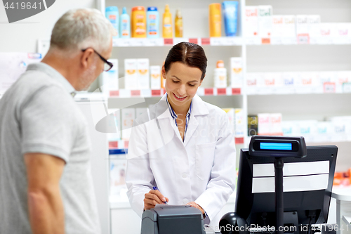 Image of apothecary and senior customer at pharmacy