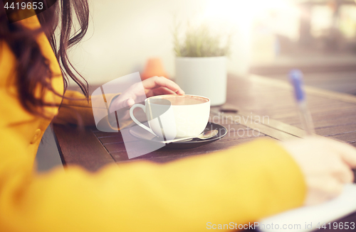 Image of close up of woman drinking cocoa at cafe