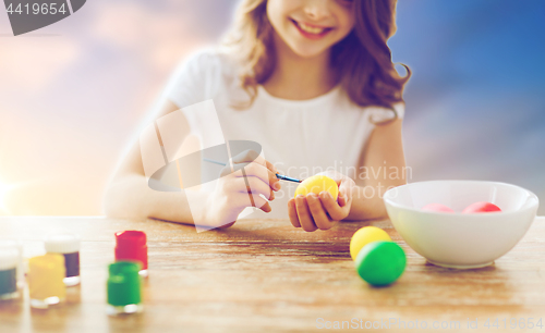 Image of close up of girl coloring easter eggs