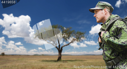 Image of soldier in military uniform with backpack hiking