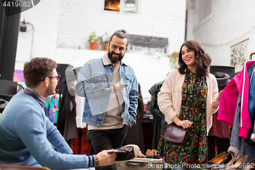 Image of friends choosing clothes at vintage clothing store