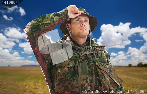 Image of soldier or traveler in military uniform over sky