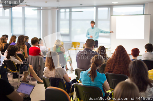 Image of Speaker giving presentation on business conference.