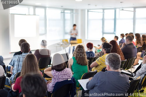 Image of Speaker giving presentation on business conference.