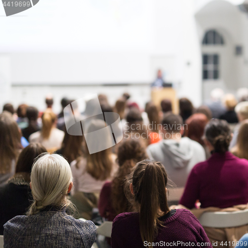 Image of Woman giving presentation in lecture hall at university.